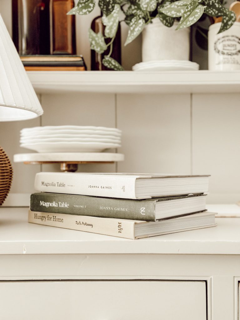 Simple fall kitchen decorations with cookbooks on a kitchen hutch.