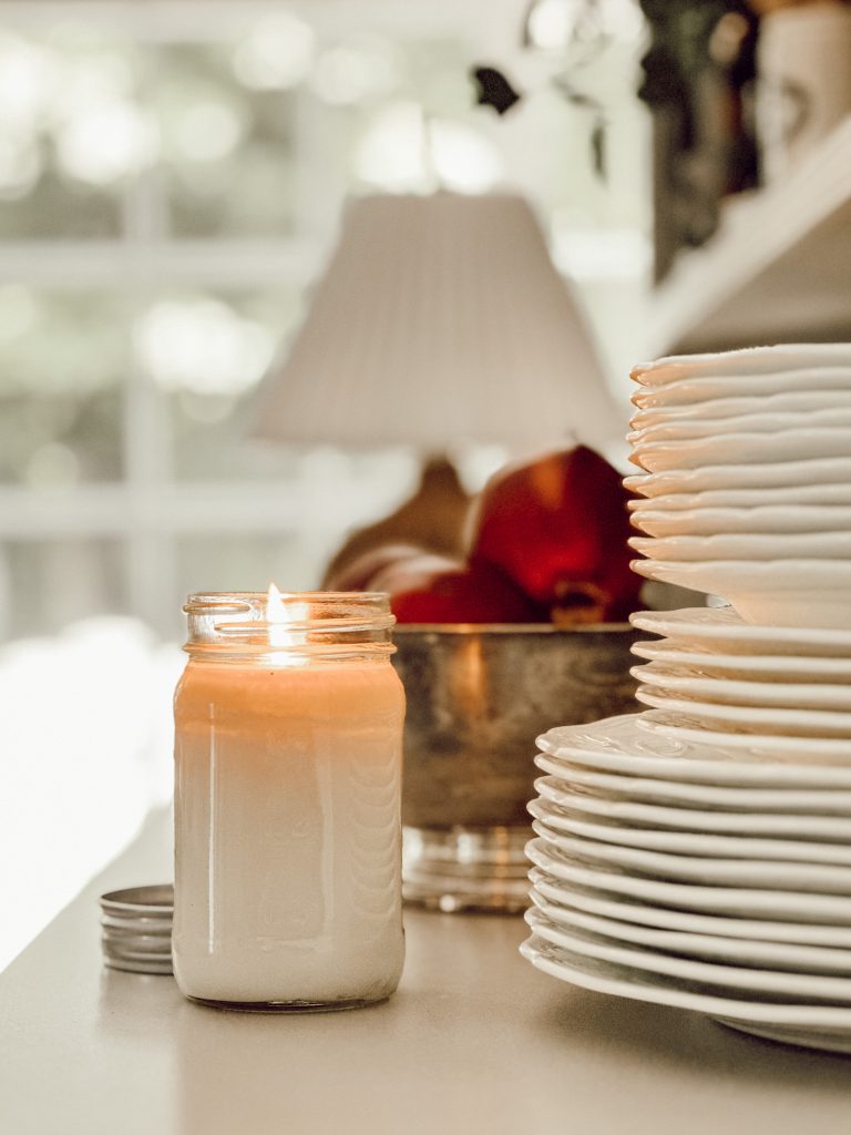 Fall scented candle in mason jar in farmhouse kitchen decor.