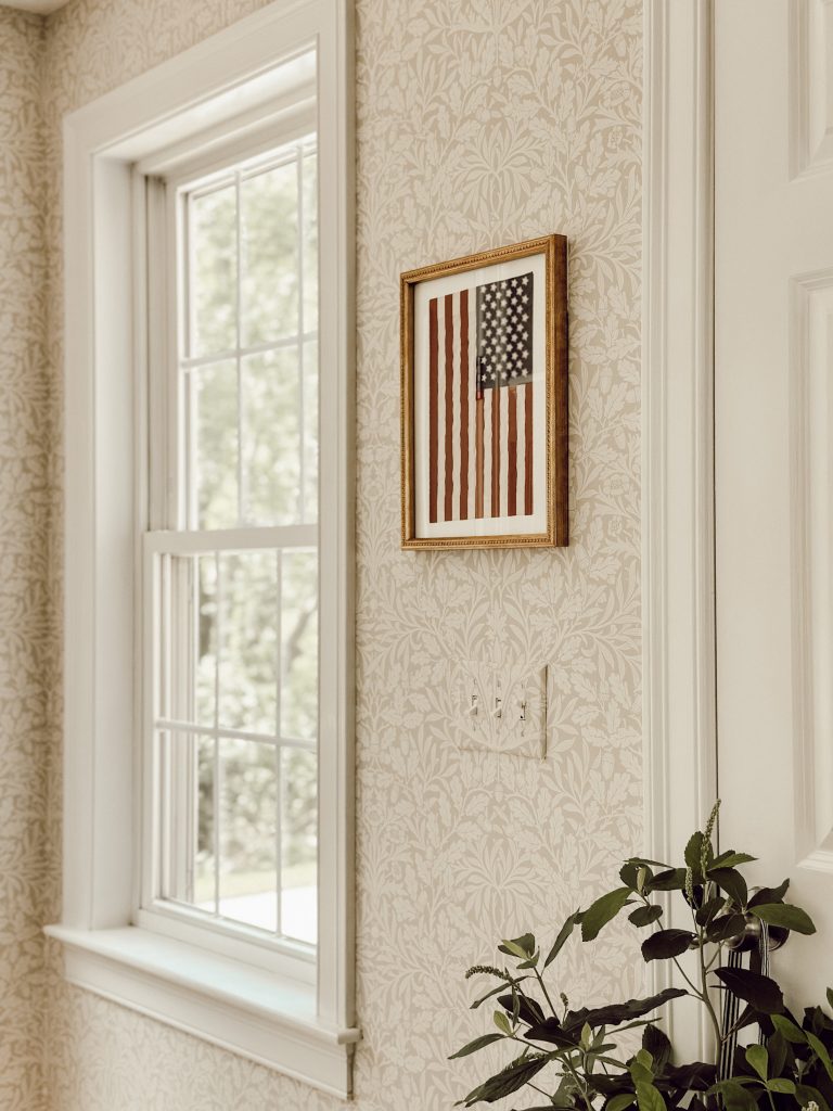 Framed patriotic decor in a cozy country farmhouse home for the summer season.