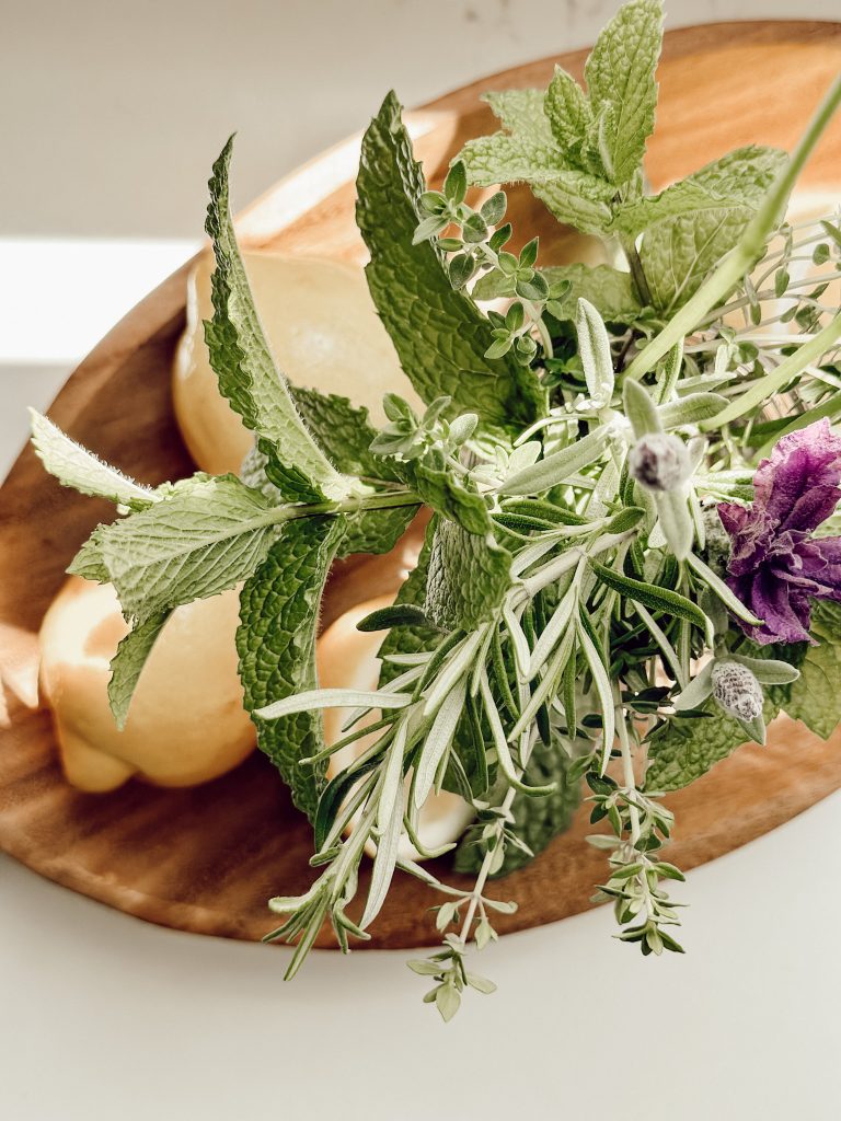 A stunning arrangement of fresh herbs in a mason jar for organic home decor.