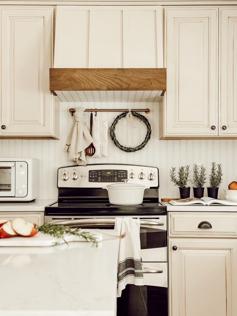 Create a fresh rosemary wreath for kitchen decor with fresh herbs, grapevine wreath, floral wire, and ribbon.