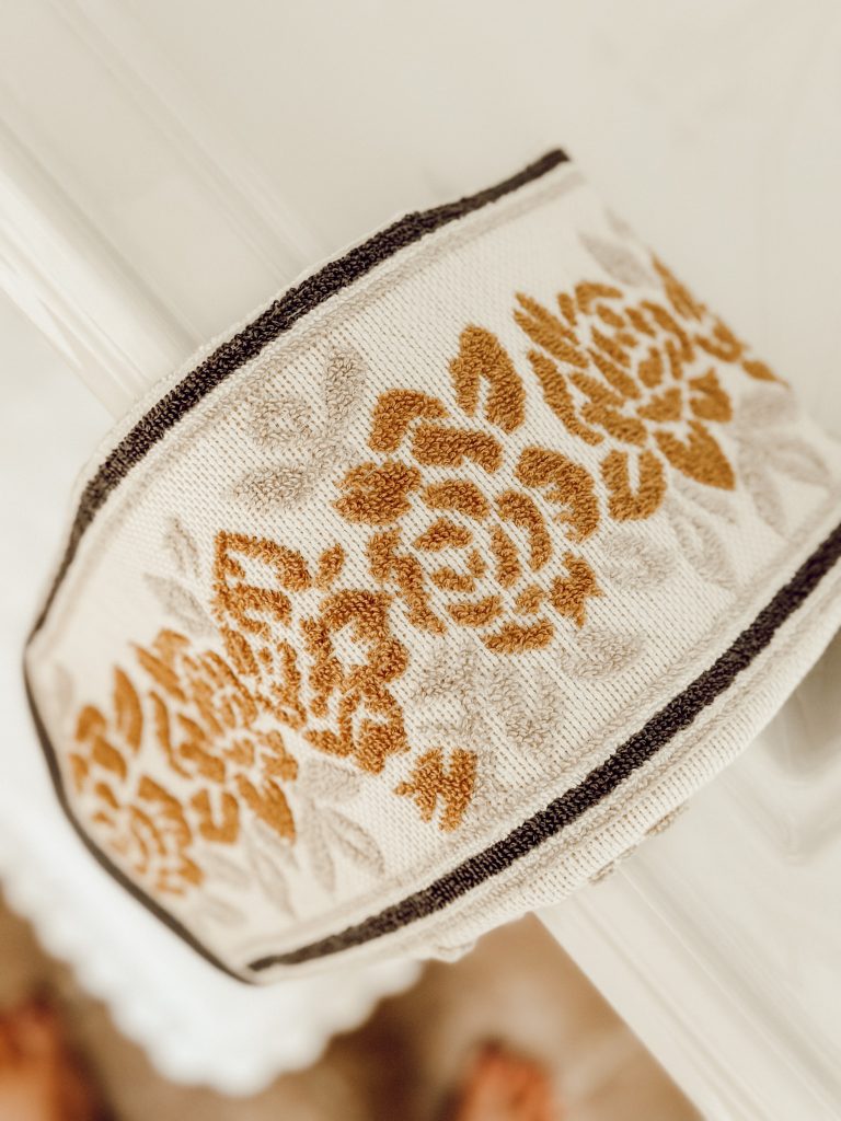 Yellow rose wallpaper pattern on a hand towel for the bathroom.