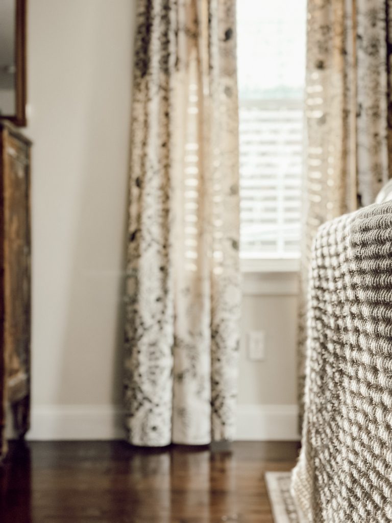 Fall coziness with a knit throw blanket draped on the back of couch.