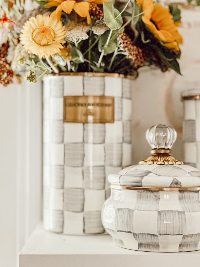 MacKenzie-Childs utensil crock used as a vase with fresh flowers inside.