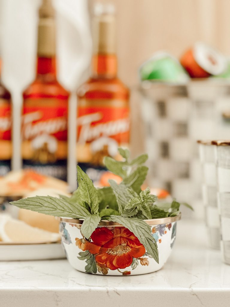 Small bowl with fresh mint leaves for garnishing glasses of lemonade.