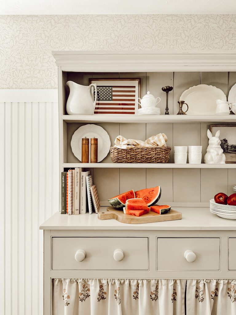 Summer patriotic decor in the kitchen with framed wall art and fresh watermelon.