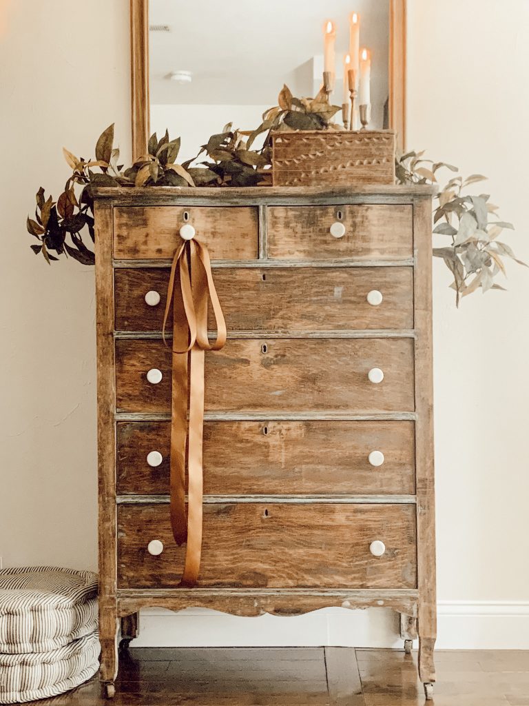 Cheap fall decorating ideas in the living room include candles and old books from the thrift store.