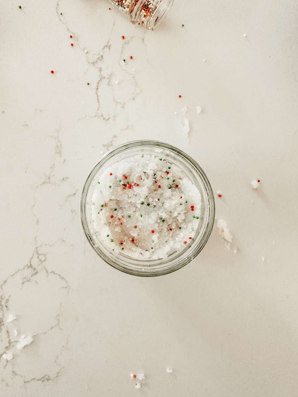 Christmas sugar cookie hand scrub in a small mason jar to moisturize your hands during the winter months.