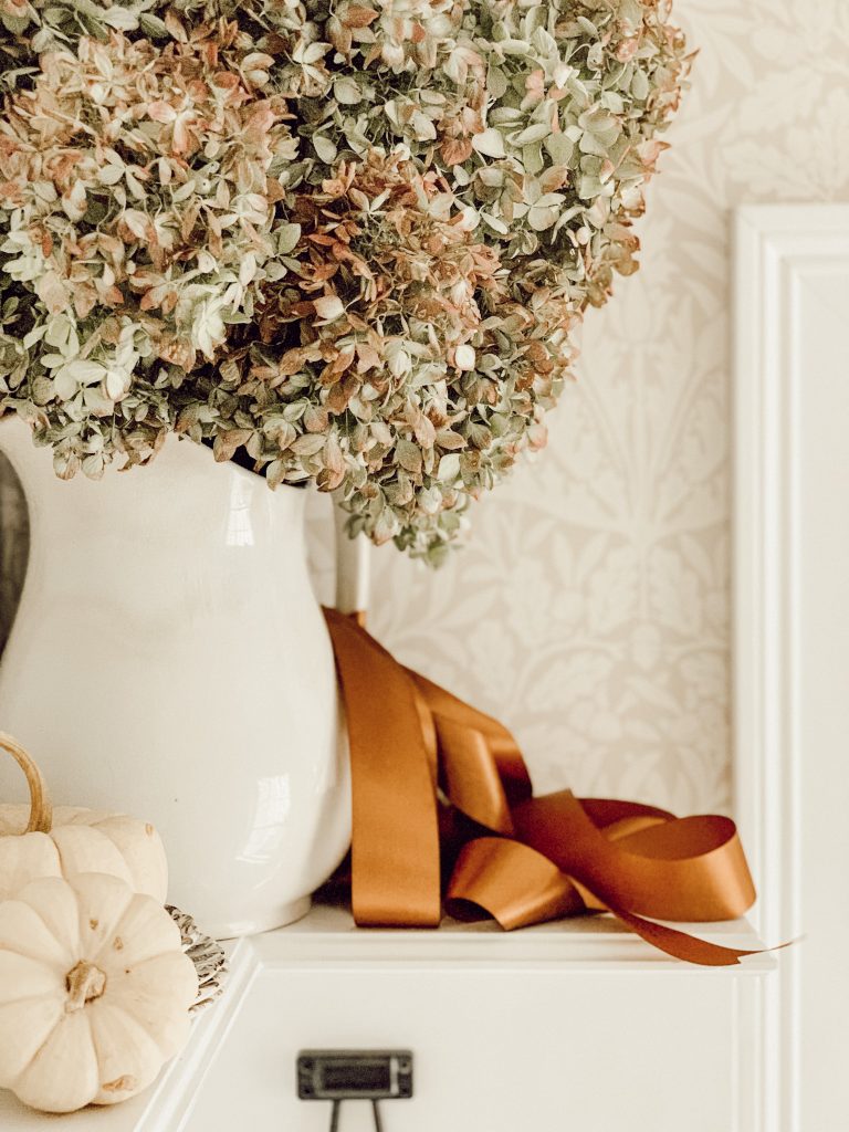 Dried hydrangeas in an ironstone pitcher adds a natural element to fall decorations.
