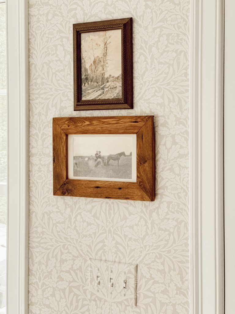Home decor in entryway with framed fall art and an heirloom family photograph.