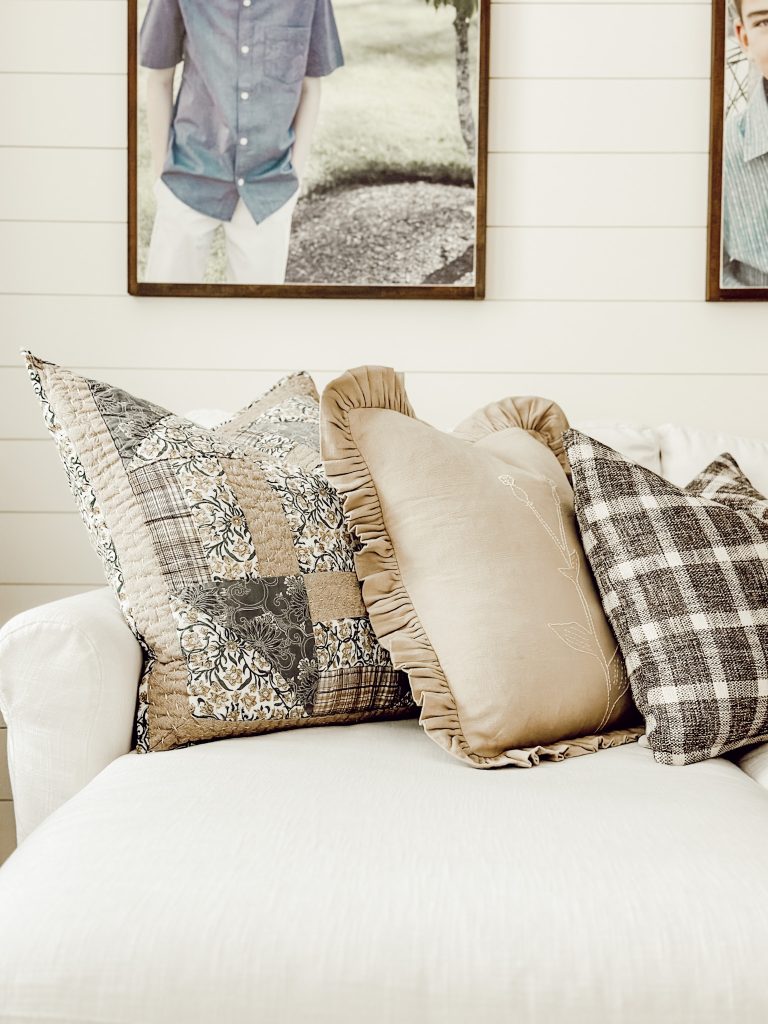 Three different throw pillows on living room couch to added coziness.