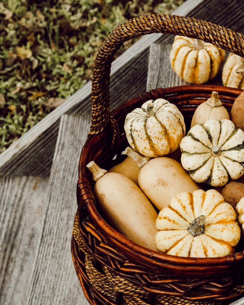Fill a woven basket with pumpkins, gourds, pine cones, or other seasonal decor.