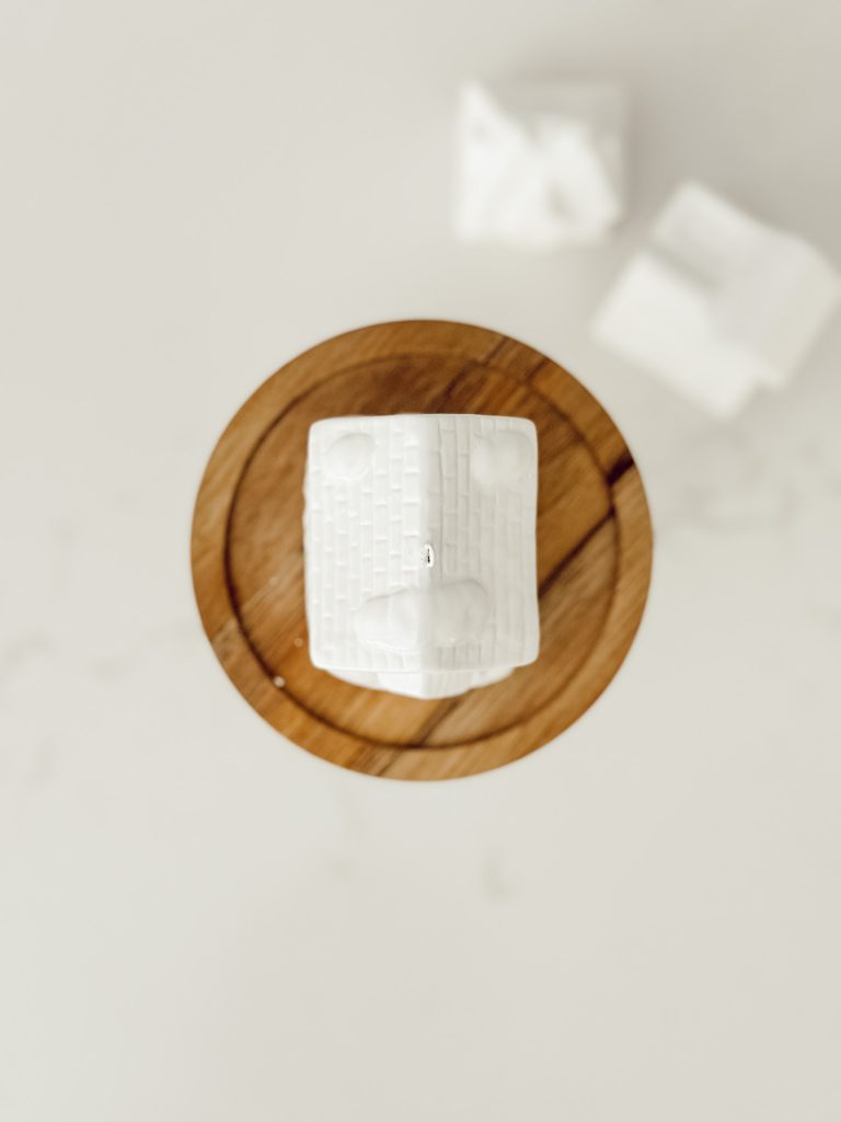 Ceramic house Christmas ornament hot glued to the glass jar lid.