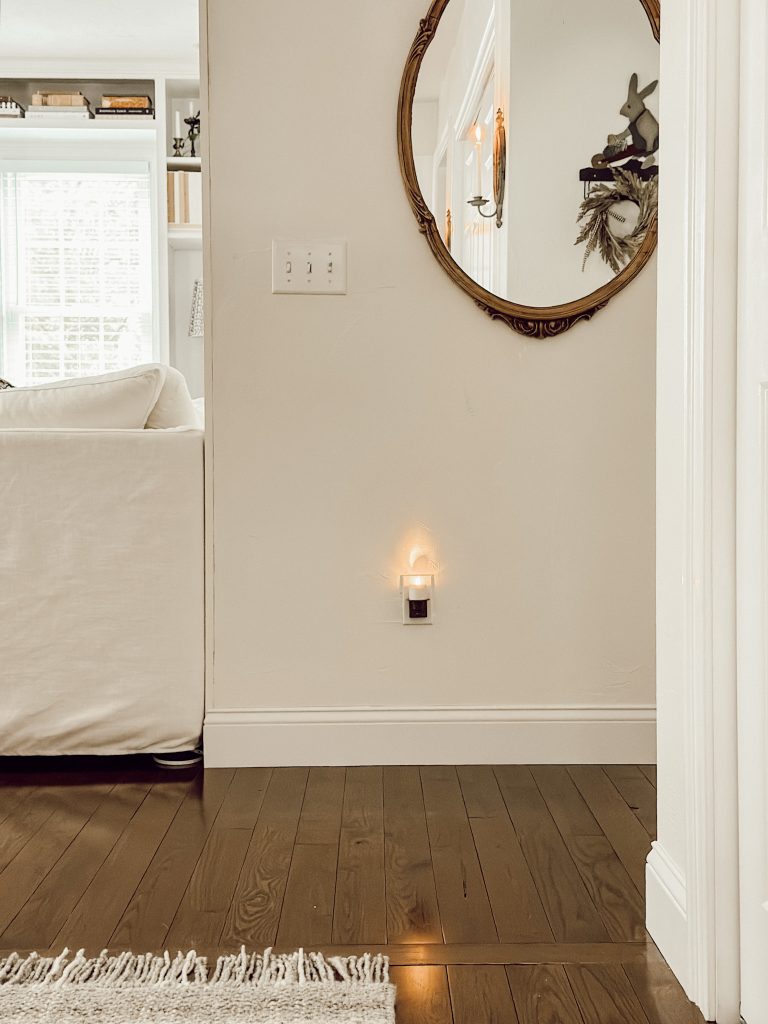 Flameless candle night light from Amazon with flickering flame and bronze colored base.