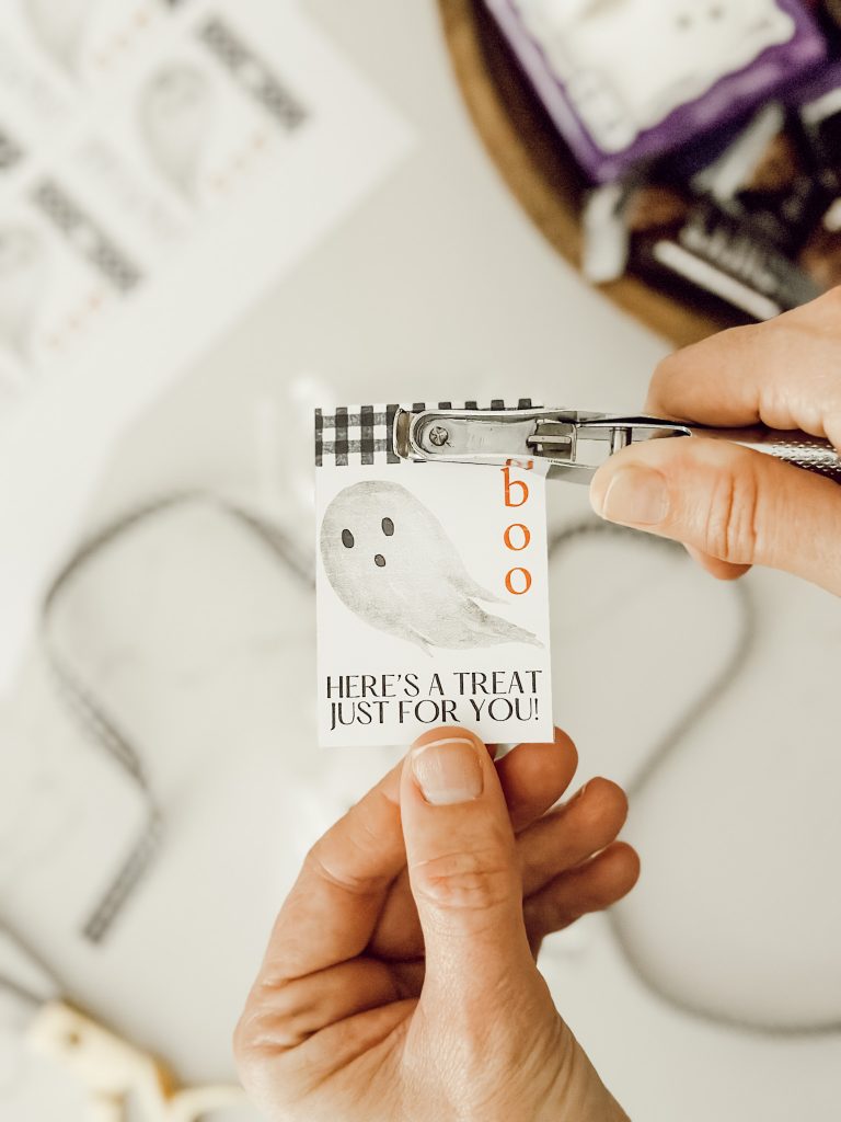 Use a hole punch to create a hole in the Halloween printable gift tag.