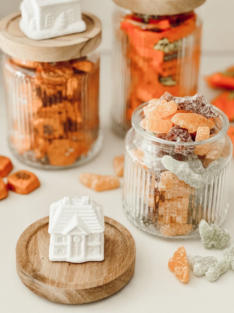 Homemade candy jars filled with sweet treats like chocolate and gummies.