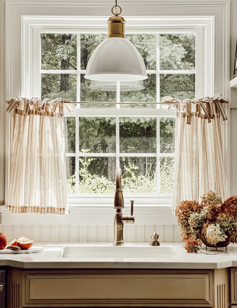 Striped cafe curtain hanging on kitchen window from Amazon Home.