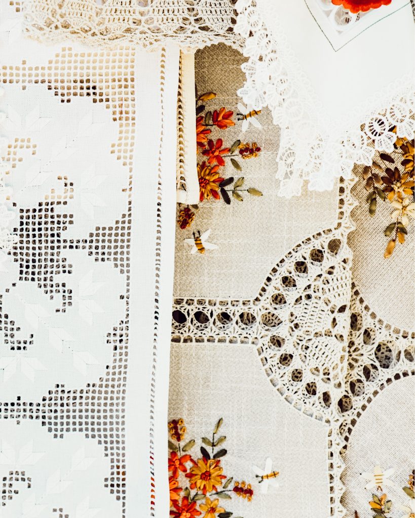 Vintage linens including lace and crocheted doilies are a great way to dress up your holiday tablescapes.