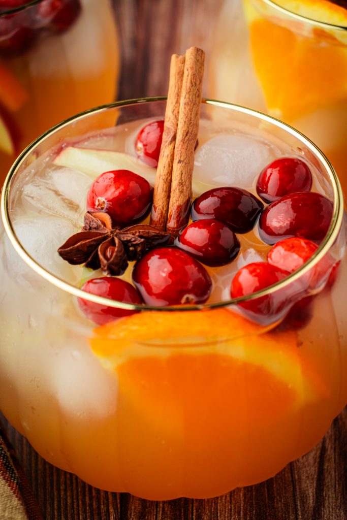 Fall beverage with cinnamon sticks and fresh fruit for Thanksgiving dinner.