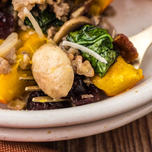 Mushrooms, spinach, and dried cranberries in stuffed pumpkin.