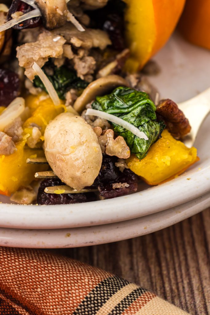 Mushrooms, spinach, and dried cranberries in stuffed pumpkin.