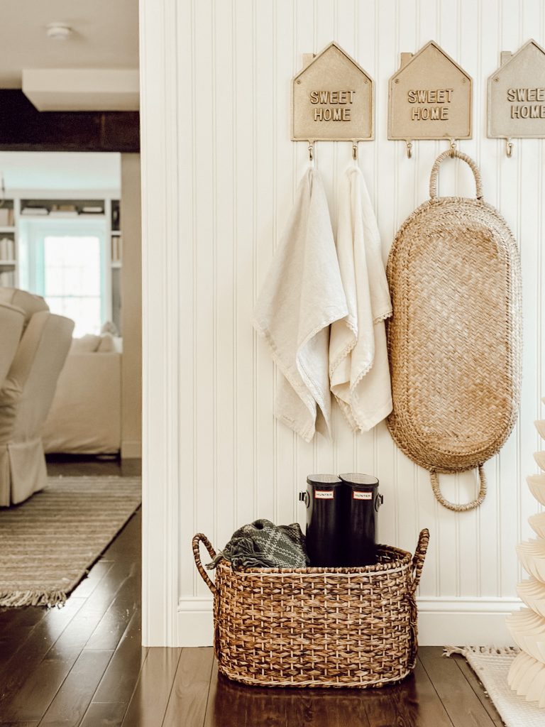 Holiday decorations in a neutral color scheme in the entryway of our home.