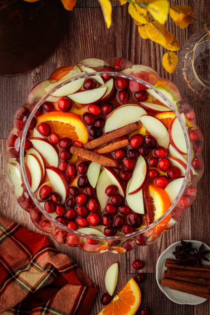 Sangria in punch bowl with fresh fruit that says happy thanksgiving.