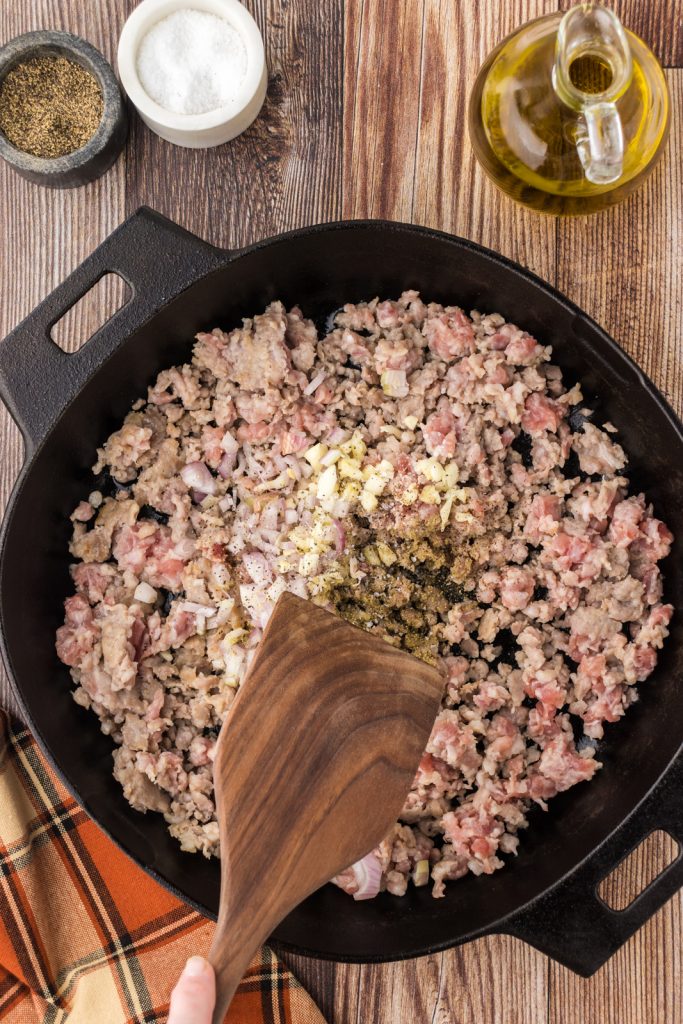 Combining the ingredients for the sausage filling in a large skillet.