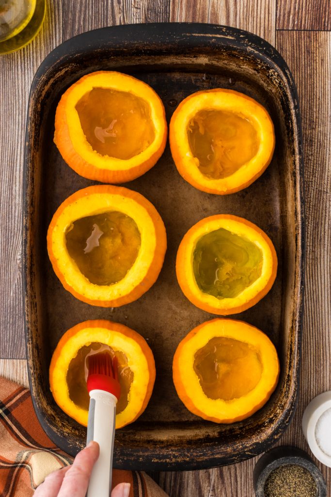Small orange pumpkins in a baking dish to bake in the oven for a comfort food meal.