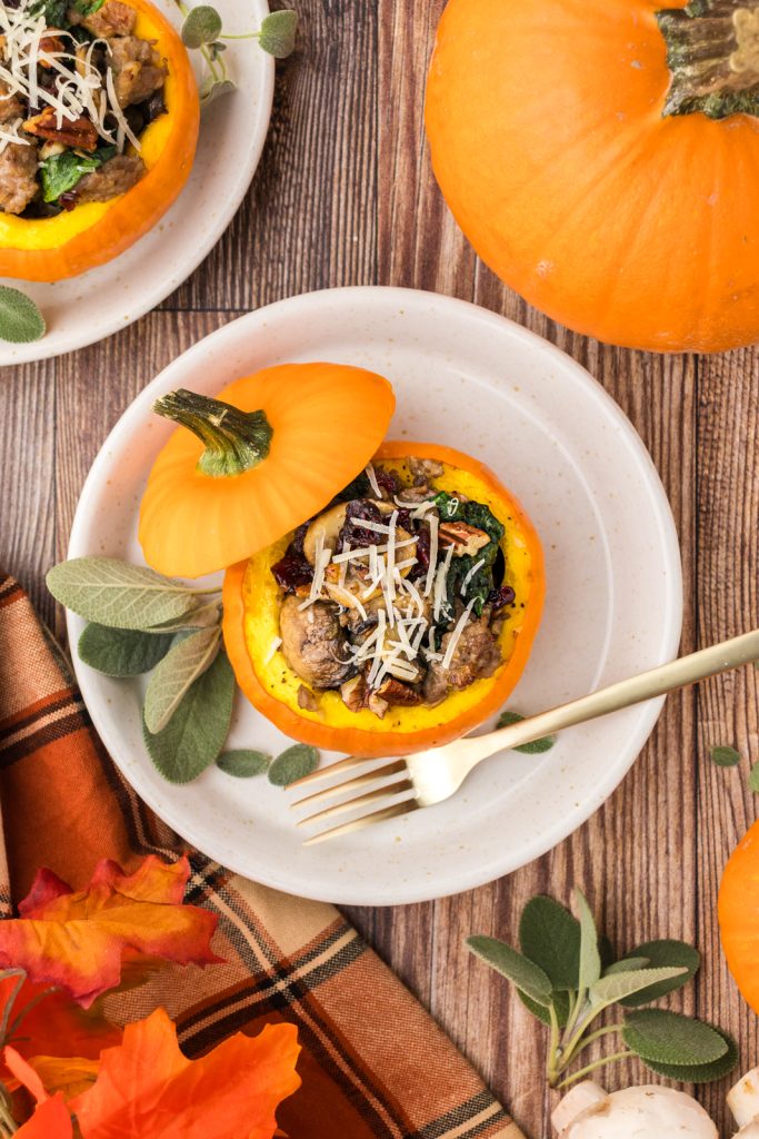 Small whole pumpkins stuffed with sausage stuffing for Halloween dinner or Thanksgiving.