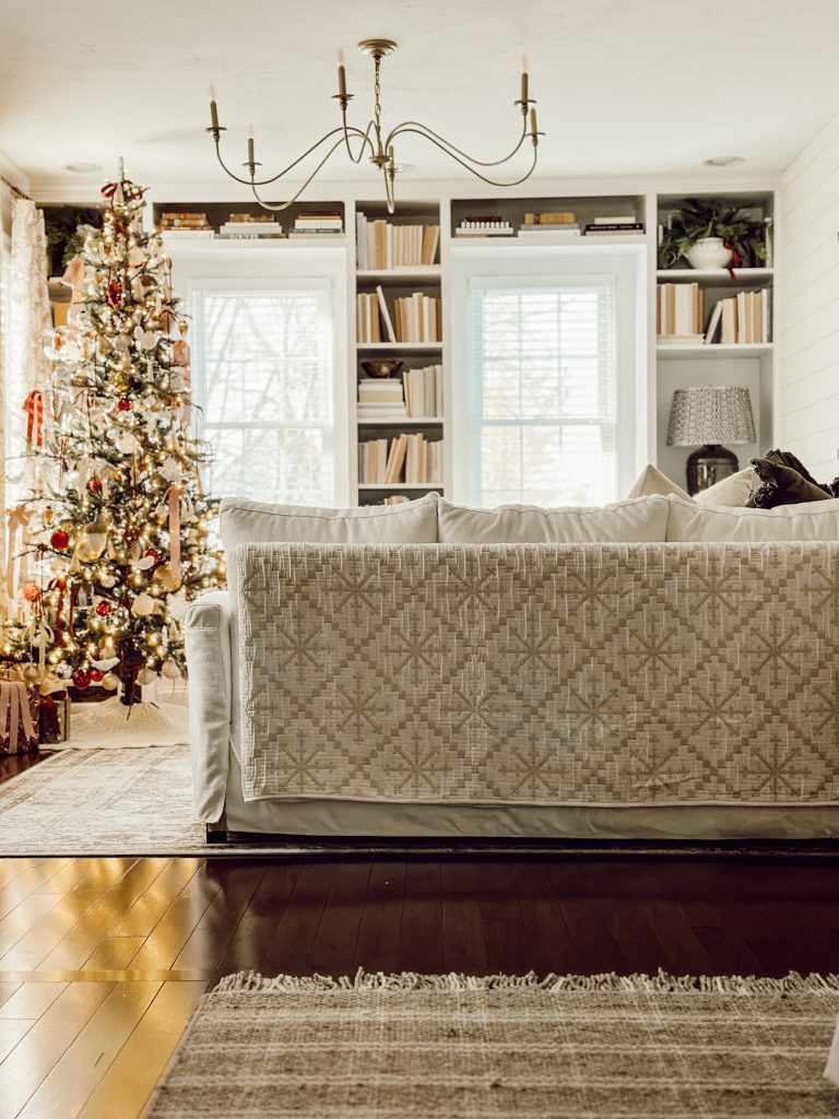 Cozy quilt draped on living room sofa for the winter season.