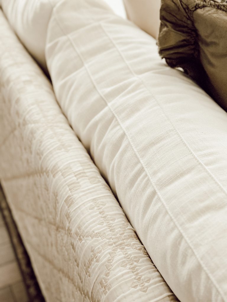 Cozy winter quilt on living room sofa for comfort, warmth, and coziness.