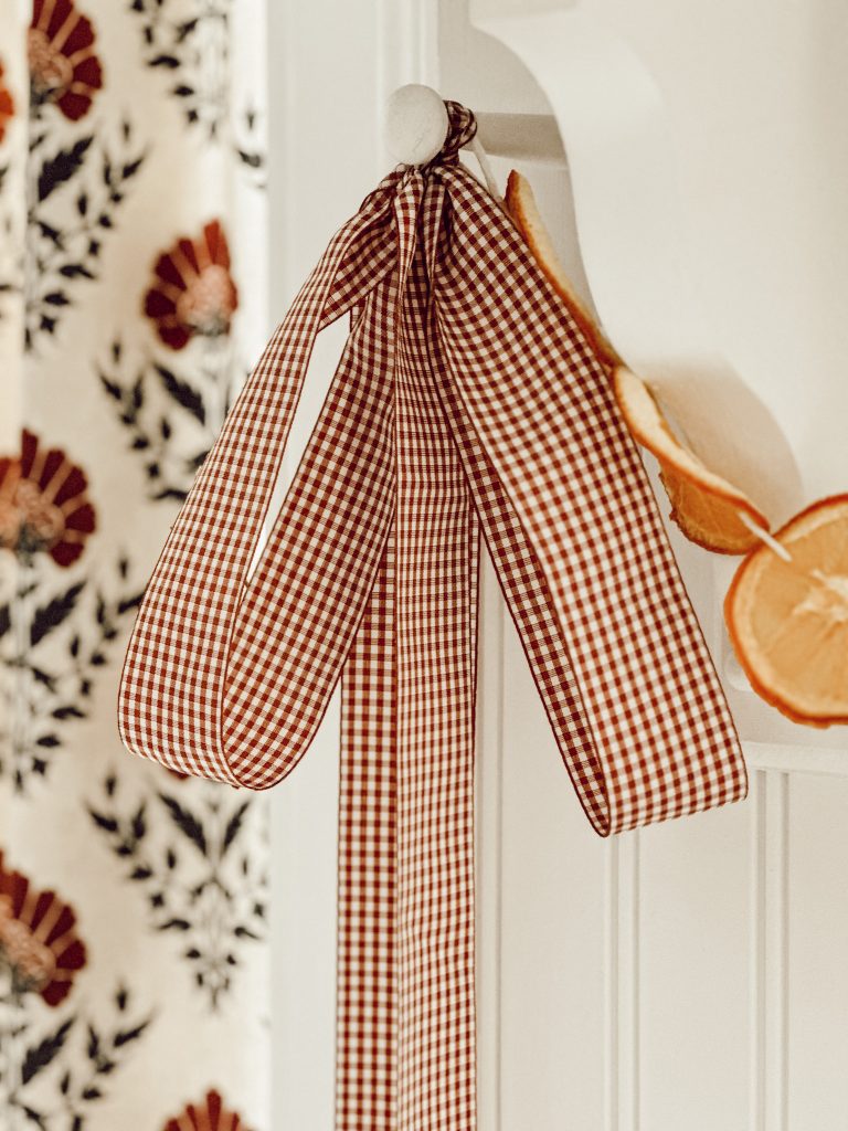 A great way to hang a garland is by using wide ribbon to secure the ends to peg hooks.