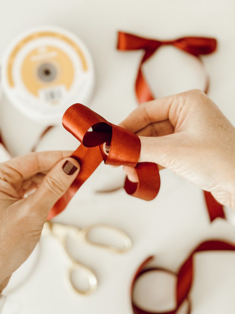 Make another loop to make a Christmas bow with the satin ribbon.