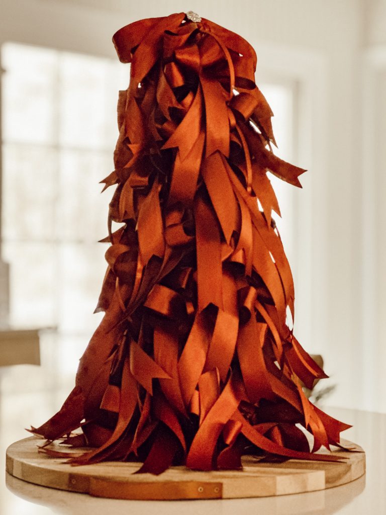 Homemade bow Christmas tree displayed on kitchen island for festive cheer.
