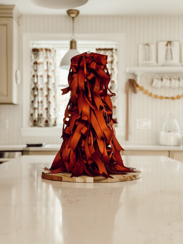 Handmade holiday decor with this DIY tree made with ribbon and a cone.