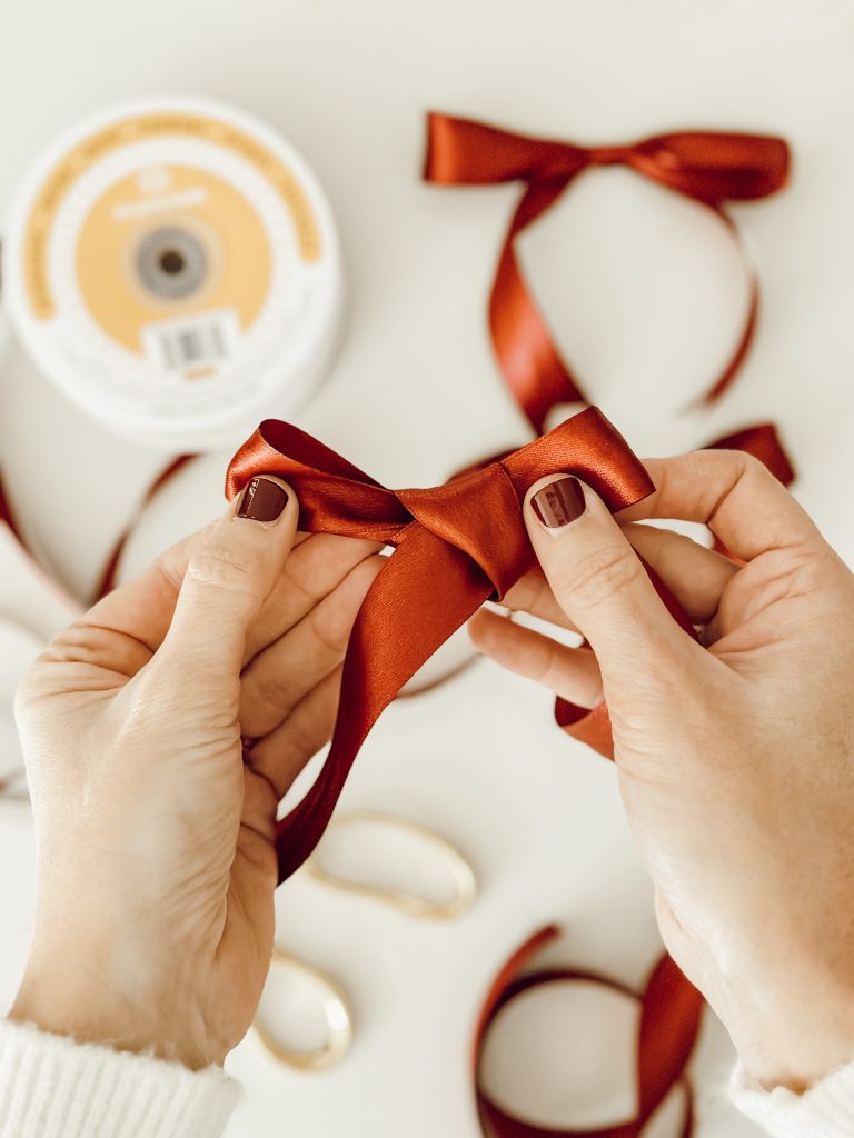 Pull the loops of the bow to create a classic bow that you can use for holiday DIY projects.