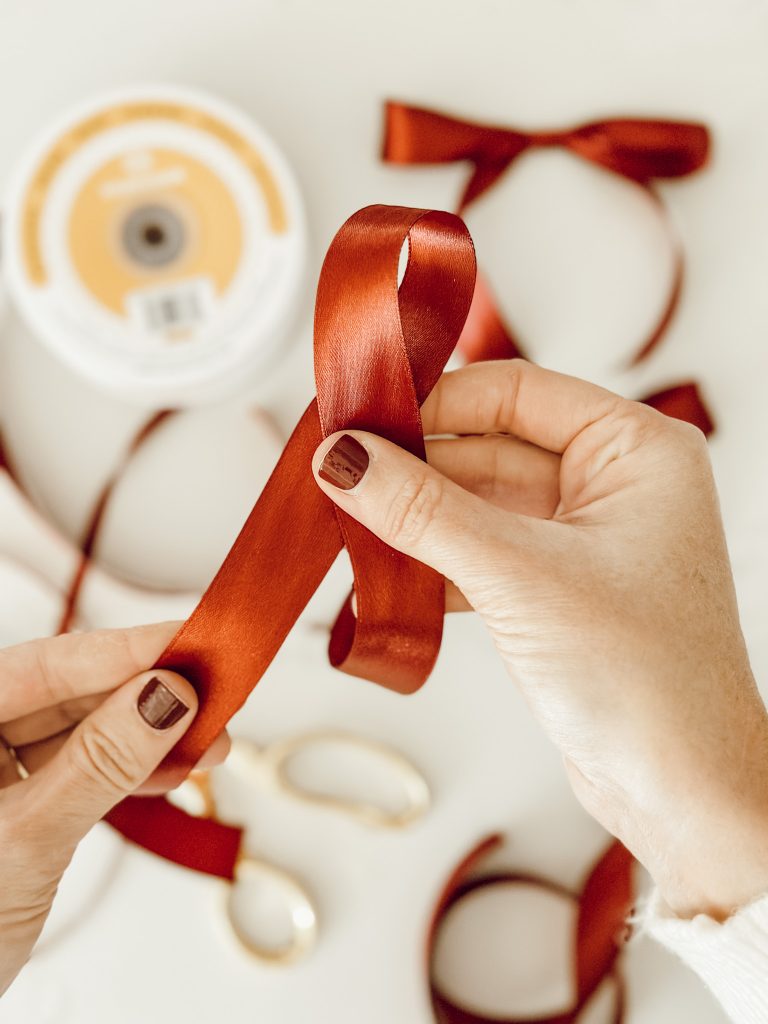 Make a loop with the Christmas ribbon to begin tying into a bow.