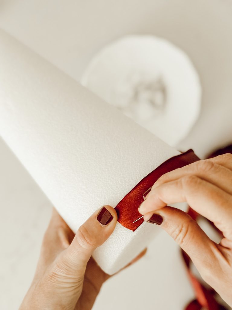 For this Christmas DIY you'll need a styrofoam cone and burgundy satin ribbon.
