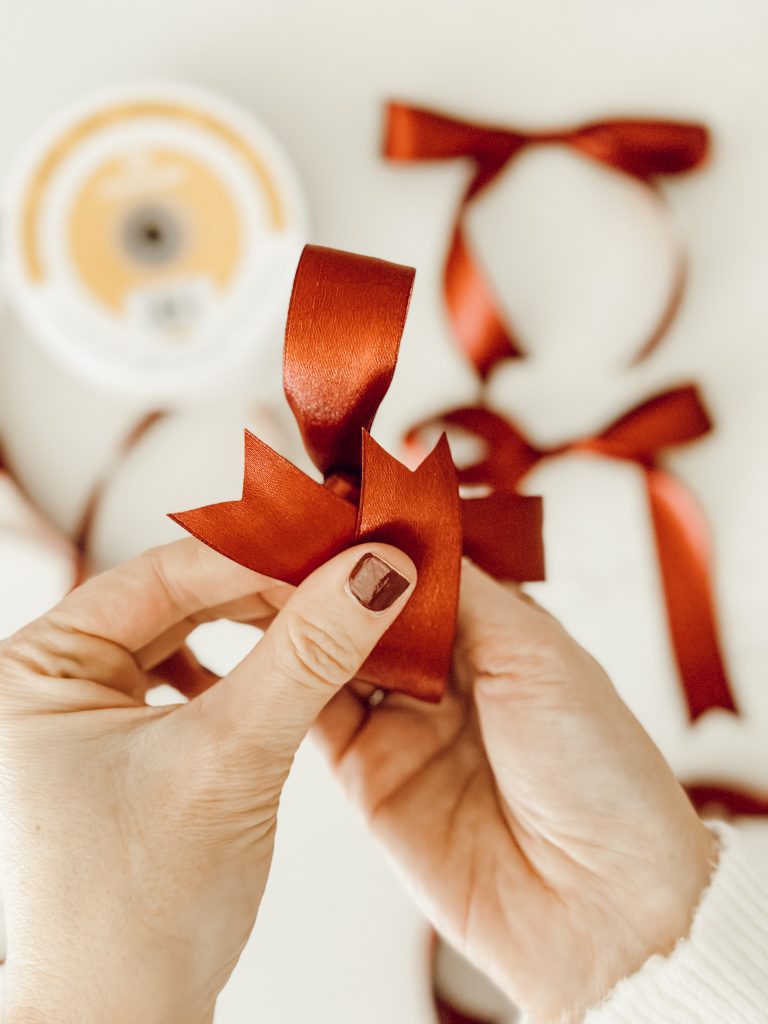 Trim the tails of the bow to create a polished look for the DIY holiday tree.