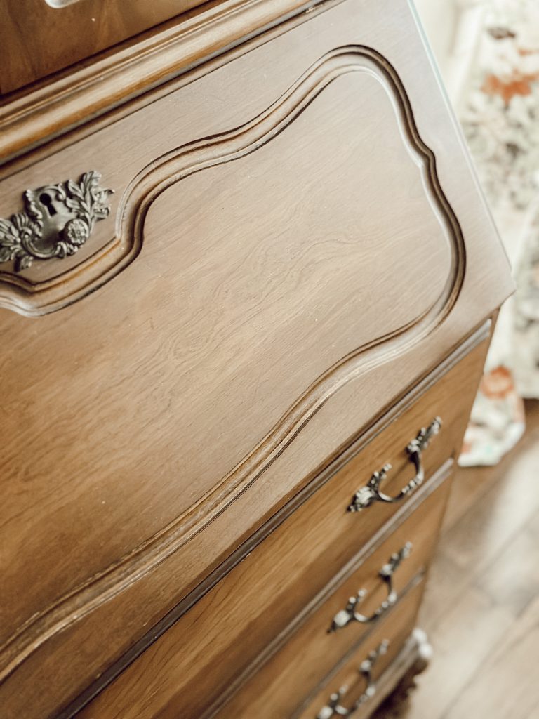 The curved woodwork adds character and personality to this vintage secretary desk.
