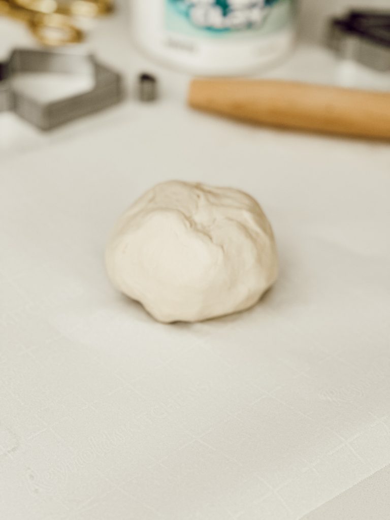 The first step to making DIY coasters is grabbing a handful of air-dry clay.