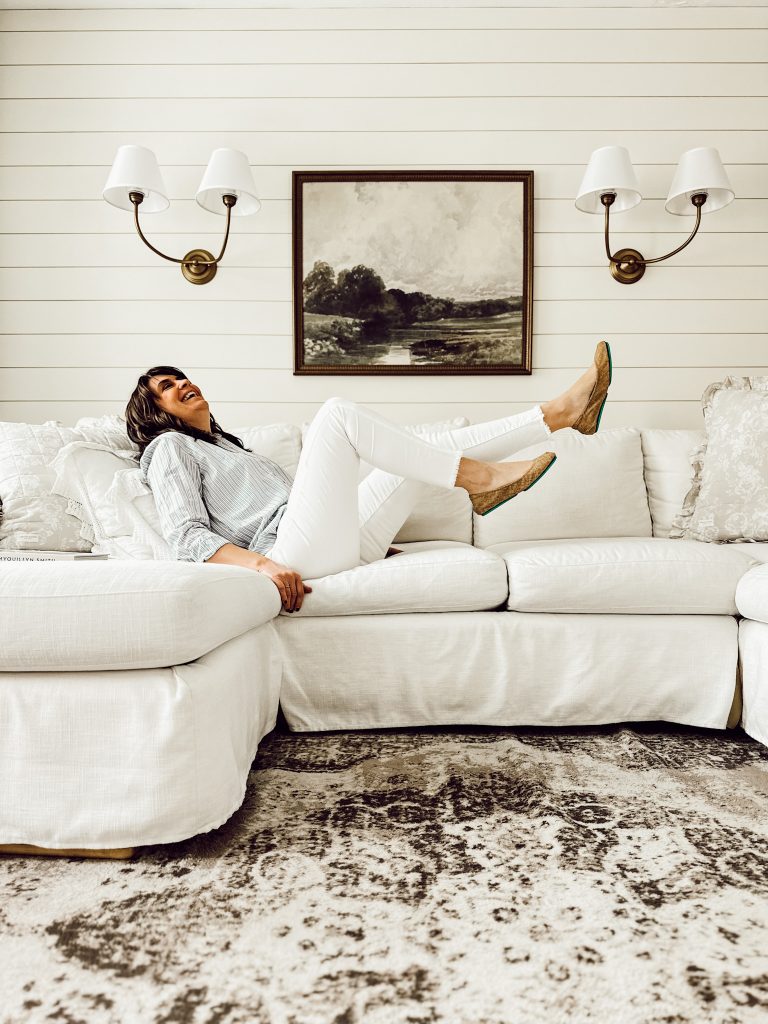 Comfortable ballet flats Tieks by Gavrieli on Heidi with white jeans and cozy top on white living room sofa.