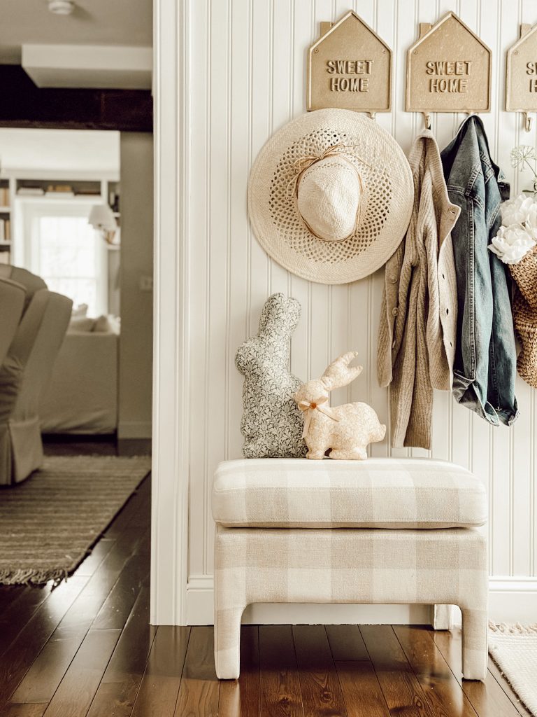 Easy spring decor with charming rabbit shaped decorative pillows on a gingham bench.