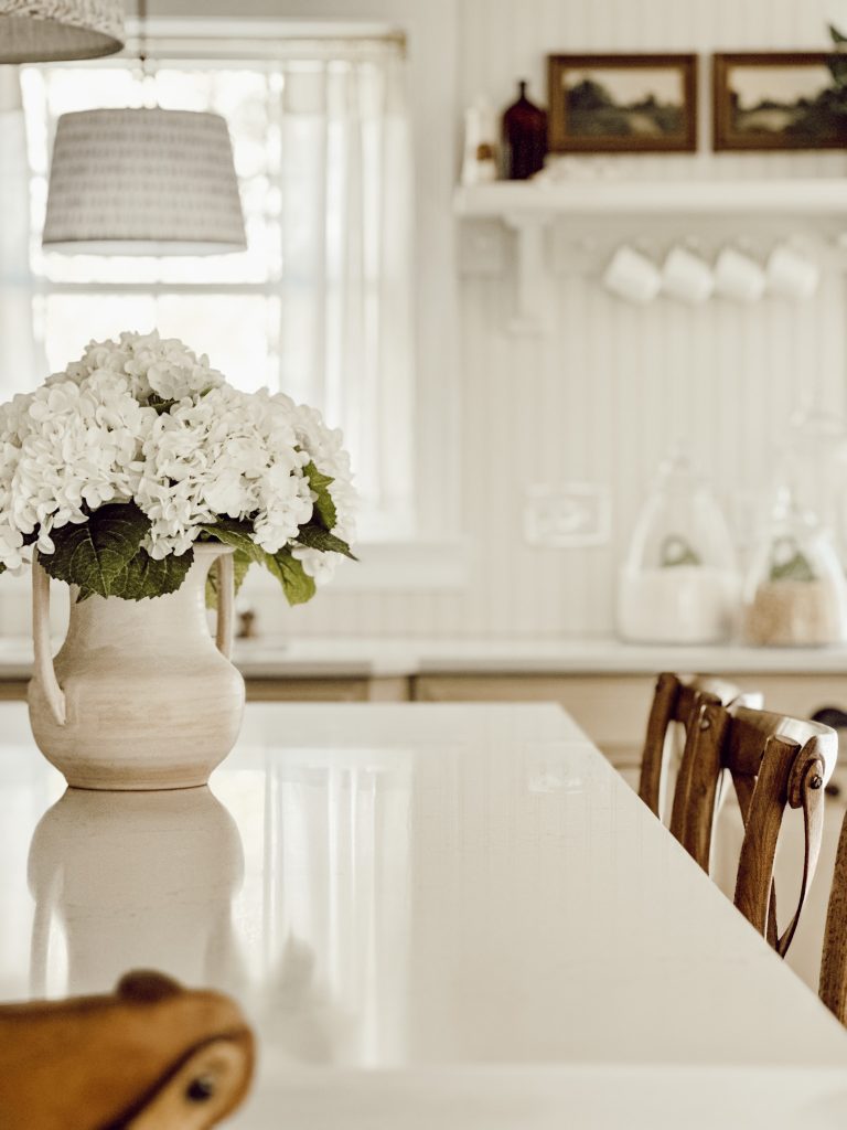 Liberty Gold quartz kitchen countertop on the kitchen island with a vase full of hydrangeas.