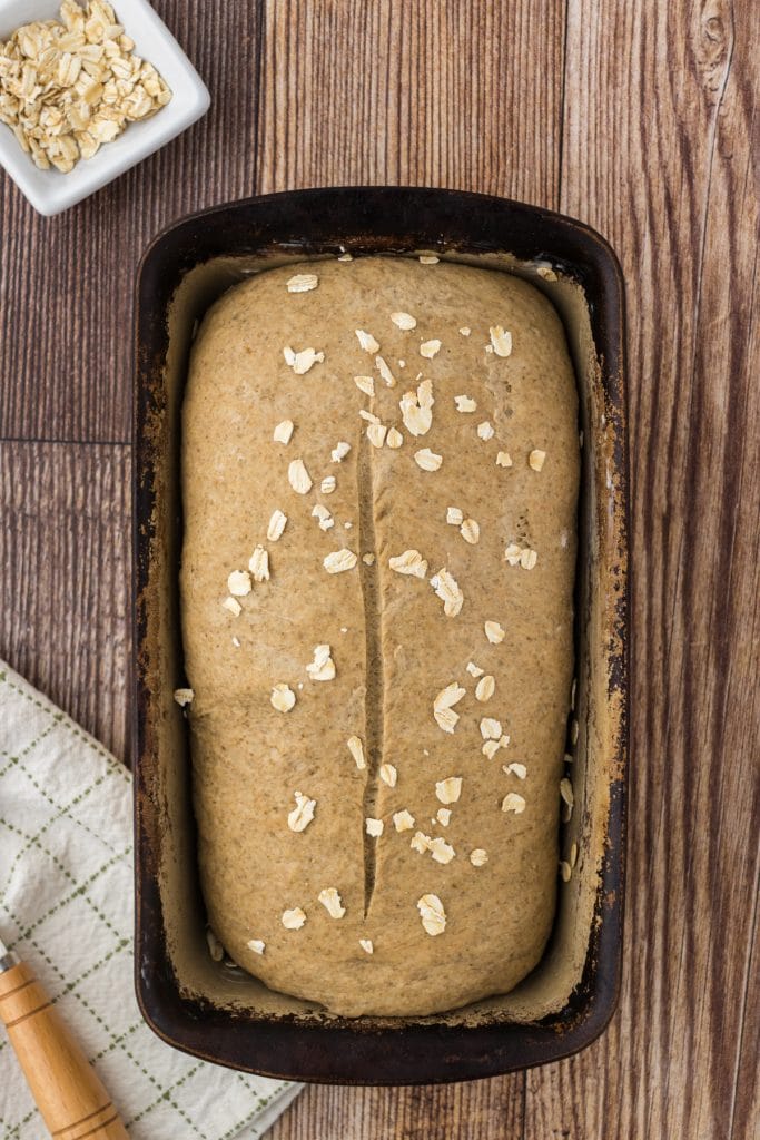 Loaf of Irish honey black bread with quick oats on top ready to go into the oven for baking.