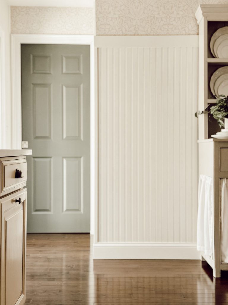 DIY Kitchen decor ideas include installing timeless wallpaper and breadboard walls for character.