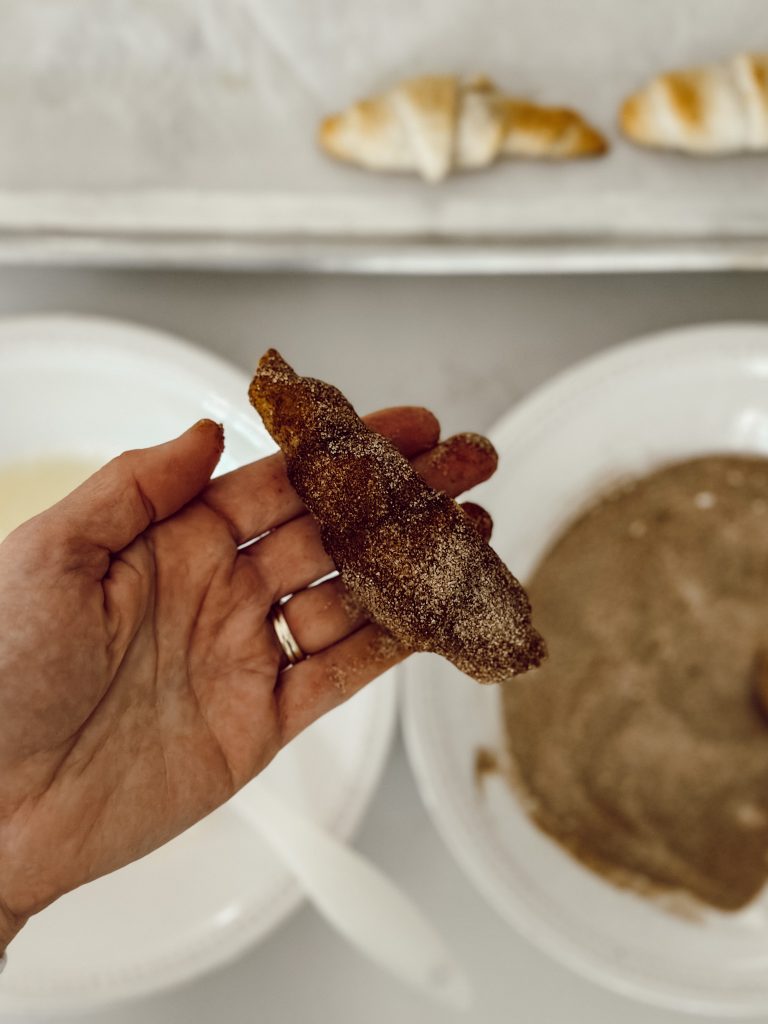 Baked crescent roll covered in cinnamon sugar to make traditional churros.