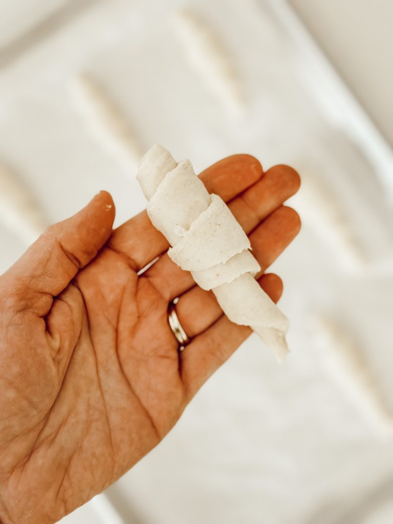 Separate the crescent roll triangles and roll each one into a crescent shape and then place on a parchment paper lined baking sheet.
