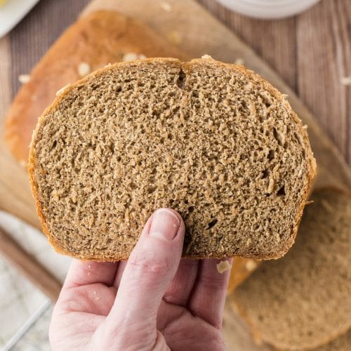 A slice of homemade honey black bread showing it's hearty texture.